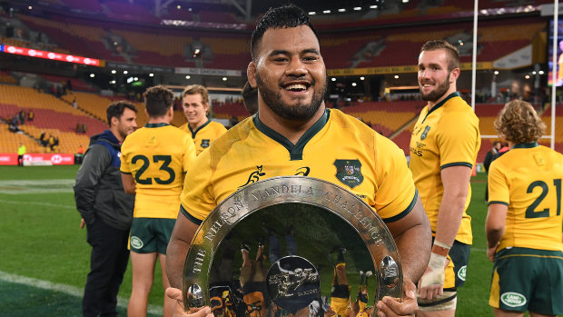 Impressive: Taniela Tupou holds the Mandela Plate after the Wallabies' win in Brisbane. 