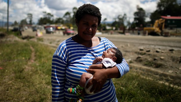 Ruth Ismile with her son, Carlvert, after he received his tetanus vaccination  at a mobile clinic.