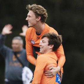Lachie Whitfield hamming it up with Toby Greene at GWS Giants training on Friday.