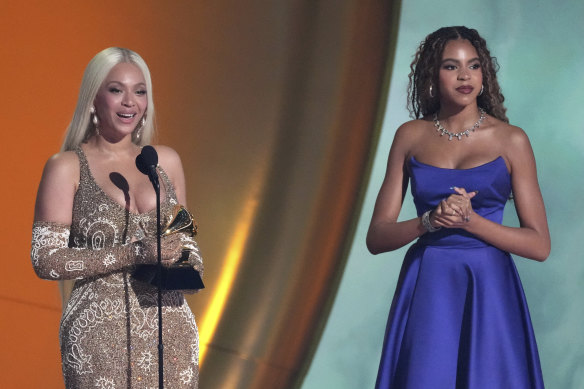 Beyonce accepts the award for album of the year with daughter Blue Ivy.