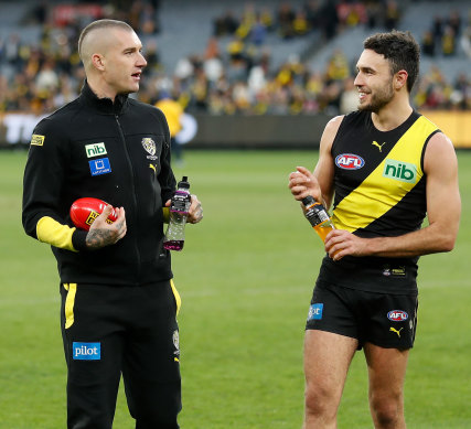 Dustin Martin in his tracksuit after the game, with Shane Edwards.