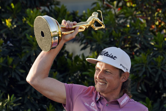 Cameron Smith hold the Players Championship trophy aloft after the biggest win of his career.