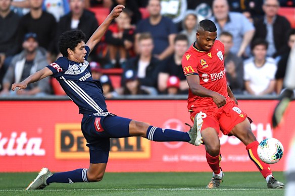 Melbourne's Brandon Lauton, left, tackles Michaël Maria, right, who scored a goal for Adelaide. 