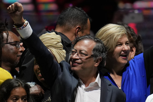 Former rebel Gustavo Petro and his wife Veronica Alcocer celebrate before supporters after winning a runoff presidential election in Bogota, Colombia.