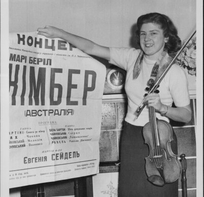 Back from Moscow with a first-class diploma for violin, Kimber shows a Russian poster advertising a concert in 1958.