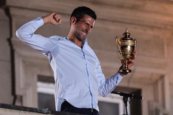 Novak Djokovic celebrates with the Wimbledon trophy in front of Belgrade City Hall.