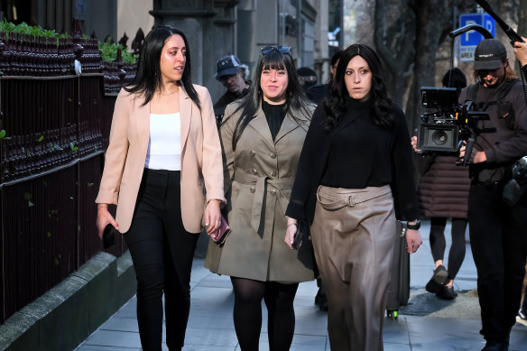Sisters Elly Sapper, Dassi Erlich and Nicole Meyer arrive at the County Court this morning.