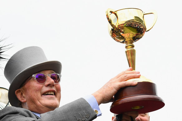 Owner Lloyd Williams holds up the Melbourne Cup after his horse Almandin stormed to victory in 2016.