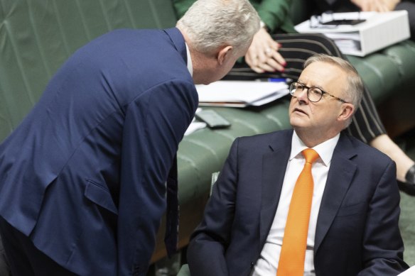 Workplace Relations Minister Tony Burke leans in to speak with Prime Minister Anthony Albanese in parliament on Wednesday.