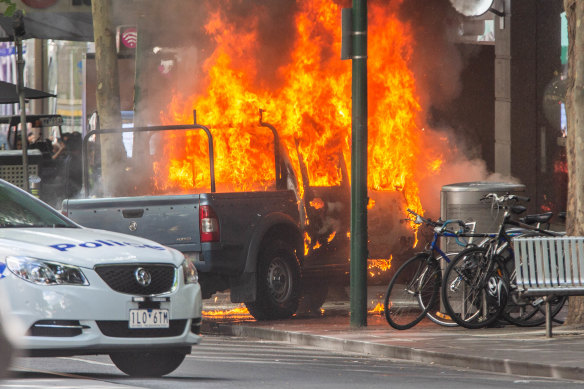 The scene on Bourke Street where Shire Ali set a car alight before killing the co-owner of Pellegrini's Espresso Bar and wounding two others in a suspected act of terror.