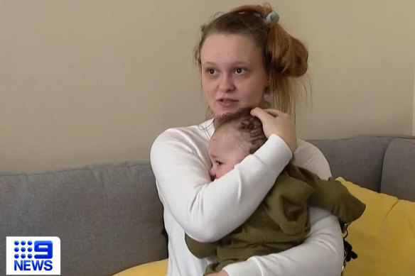 Sydney Moore  with her baby after the tornado sucked him out of the family’s mobile home.