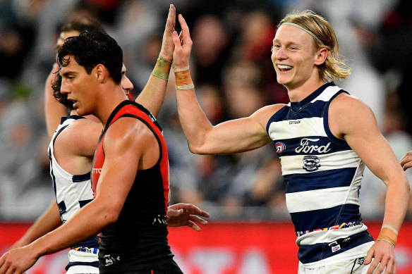 Oliver Dempsey is congratulated by teammates after kicking a goal.