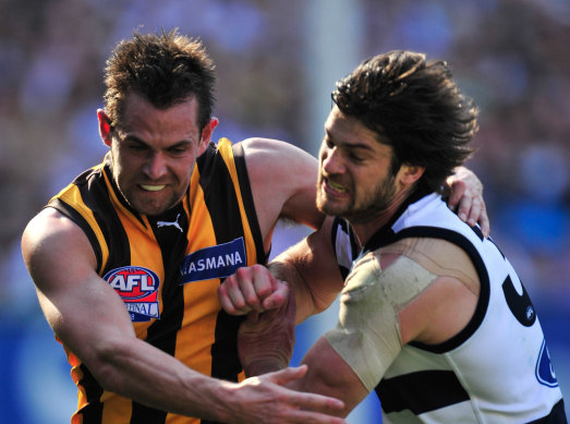 Geelong's Max Rooke, a two-time Premiership player with the Cats, battles for the ball with Hawthorn skipper Luke Hodge