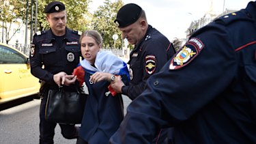 Police detain Lyubov Sobol prior to an unsanctioned rally in Moscow in July.