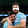 Melbourne City’s Marco Tilio and Mathew Leckie embrace after winning the A-League grand final.