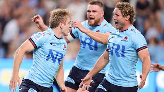 Max Jorgensen (left) celebrates with Waratahs teammates after scoring on debut against the Brumbies.