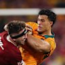 Joseph-Aukuso Suaalii of the Wallabies is tackled by Tom Curry.
