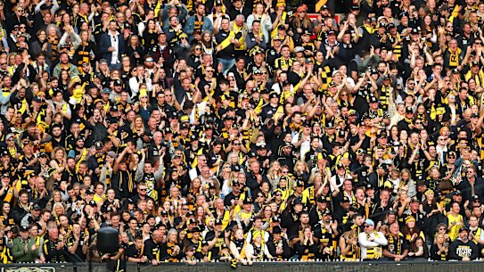 MELBOURNE, AUSTRALIA - SEPTEMBER 28: Richmond Tigers fans celebrate winning the premiership during the 2019 AFL Grand Final match between the Richmond Tigers and the Greater Western Sydney Giants at Melbourne Cricket Ground on September 28, 2019 in Melbourne, Australia. (Photo by Kelly DefinaAFL Photos/via Getty Images ) CROWD PRE-MATCH ENTERTAINMENT