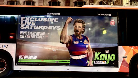 An advertisement for Kayo Sports promoting their exclusive Fox Footy AFL coverage on Saturdays.