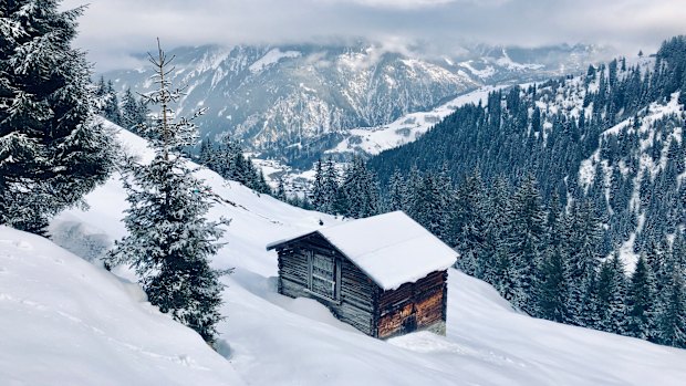 A snow-covered hutte in Switzerland’s Graubunden region.