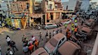 Rescuers and security workers inspect a residential building damaged by a Pakistani drone attack in Jammu, India, on Saturday.