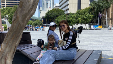 Brisbane’s King George Square February 2024. Channa Kheang and family from the Gold Coast enjoy the rare shade in King George Square
