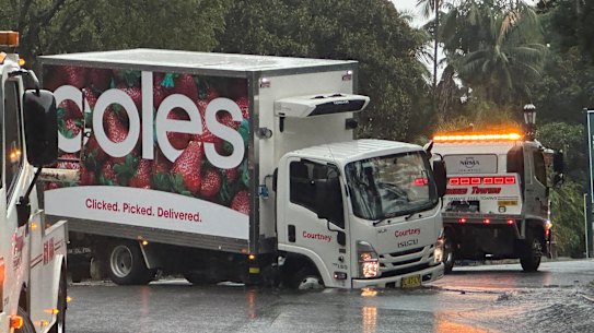 A Coles truck is stuck in a sink hole that has formed outside St Mary’s Cathedral in the Sydney CBD.