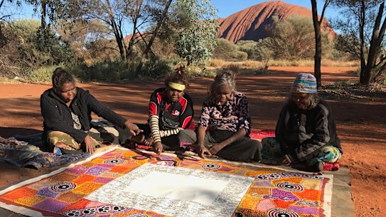 Artists complete their work on the Uluru Statement of the Heart in 2017. 