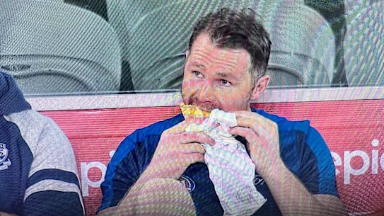Patrick Dangerfield enjoys a kebab on the bench after being subbed out by Geelong in the game against North Melbourne.