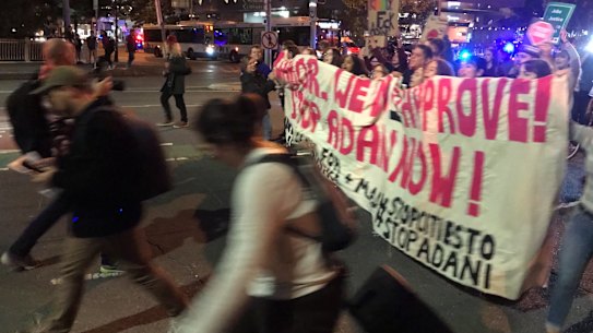 Anti-Adani protesters cross the Victoria Bridge in Brisbane on Friday, June 21, 2019.