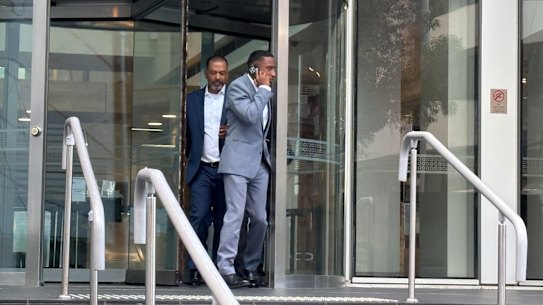 Yung Filly - real name Andres Felipe Valencia Barrientos, in the grey suit - leaves court after the first day of his trial on Monday.