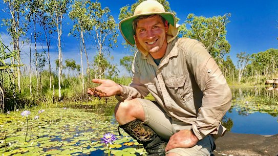 Curtin researcher Adam Cross holding a sample of the rare carnivorous plant at the site of the discovery. 