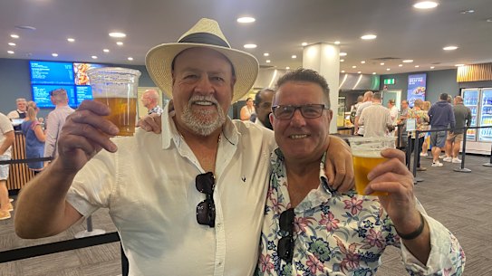 Father-of-the-groom Paul Lock, left, and father of the bride Kev Kelly enjoy the MRC’s new beer prices at Sandown.