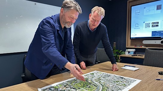 Prior + Partners director of master planning Jonathan Rose and Arcadis Brisbane Games and legacy lead Paul Allan at the firm’s Brisbane office, looking over a map of the Victoria Park site.