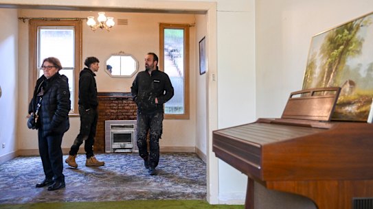 Auction spectators inspect the home at 5 Ryan Street, Coburg ahead of the competition. 