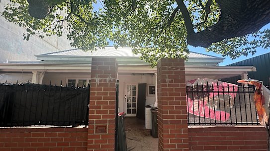 The Northbridge home is now draped with plastic, fabric and tarpaulins.
