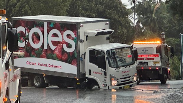 A Coles truck is stuck in a sink hole that has formed outside St Mary’s Cathedral in the Sydney CBD.