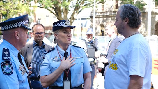 Queensland Police Commissioner Katarina Carroll meets with Voices for Victims’ Ben Cannon outside parliament.