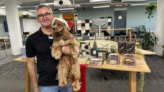 Woolworths CEO Brad Banducci and his king charles cavalier cocker spaniel cross called Juno. About 70 per cent of Australian households have a pet.