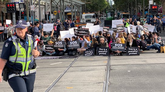 Vegan protesters block one of Melbourne's busiest intersections.