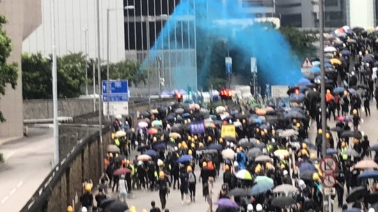 Police fire blue dye at protesters designed to identify them after they leave a scene.