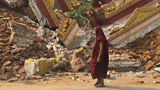 A Buddhist monk walks near a collapsed pagoda in Mandalay after Friday’s earthquake.