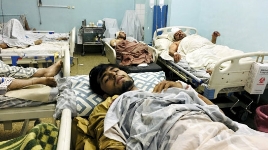 Wounded Afghans lie in hospital after the deadly explosions outside the airport in Kabul.
