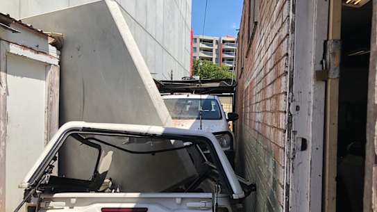 The concrete panel also appears to have crushed a car.