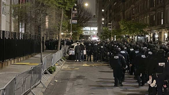 New York police officers move towards an entrance to Columbia University.