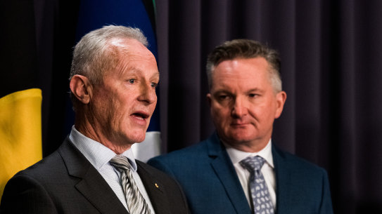 Chris Bowen listens to Greg Mullins at a press conference on Thursday.
