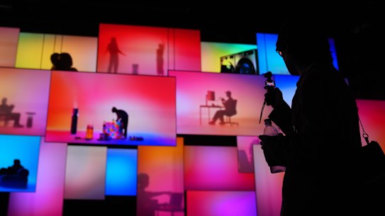 A person walks past screens at the LG Electronics booth during the CES tech show Tuesday, Jan. 6, 2026, in Las Vegas. (AP Photo/Abbie Parr)