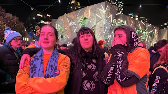 Matildas fans Stella Snowden,19; Ines de-bleye; and Ella van der Lans, 17 after the semi-final loss to England at Federation Square.