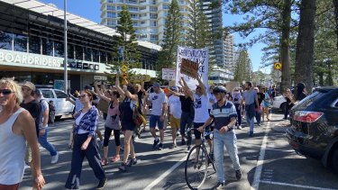 Protesters marched down the Esplanade at Coolangatta before congregating at the NSW border on Sunday