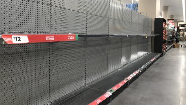 Empty shelves in the toilet paper aisle at Woolworths in Bondi Junction, NSW.
 
